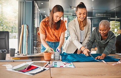 Buy stock photo Happy, women and cutting fabric as fashion designer at office with patterns or clothes on project . Startup, employees and creative director with teamwork, collaboration or coworking as stylist