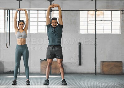 Buy stock photo Fitness, active and healthy couple stretching, exercising or training together inside gym. Two young fit trainer doing a full body workout exercise or warmup routine in the day time with copy space