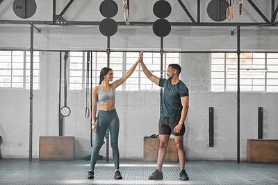 Buy stock photo Fit, active and healthy sports athletes training together in gym workout room, living a strong wellness lifestyle. Male and female fitness instructors high five and smiles in physical exercise class