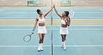 Young girls celebrate after a tennis match. Professional athletes motivate each other with a high five. African american players support each other after tennis practice. Tennis players high five.