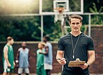 Basketball coach on court training team for game, tournament and competition outside. Confident, trainer and man focus on workout or teamwork to prepare, motivation and plan play strategy at practice