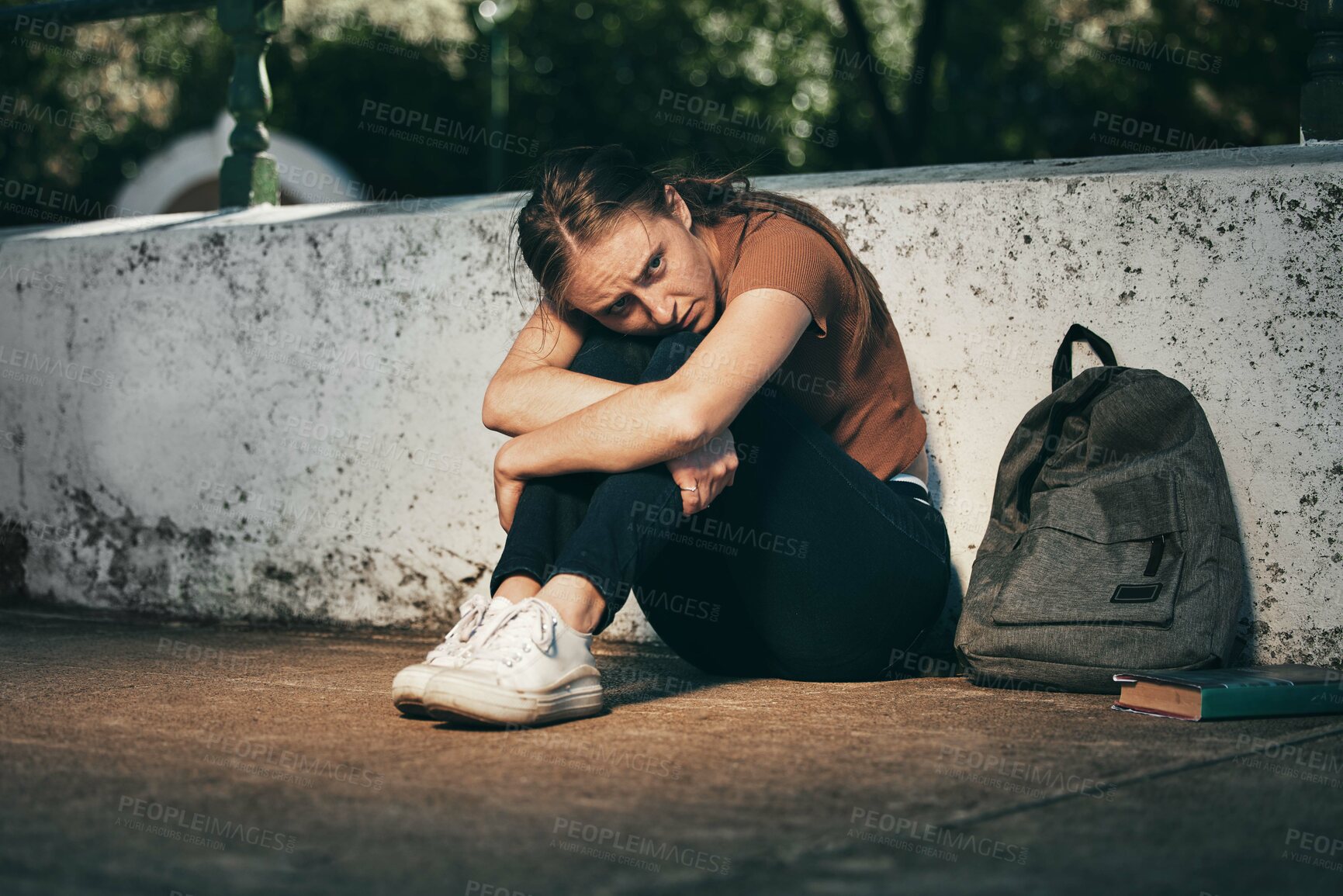 Buy stock photo Woman, student and depression in lonely stress, anxiety or mental health problems in the outdoors. Sad and depressed female teenager in distress, loneliness or trouble   at school or university