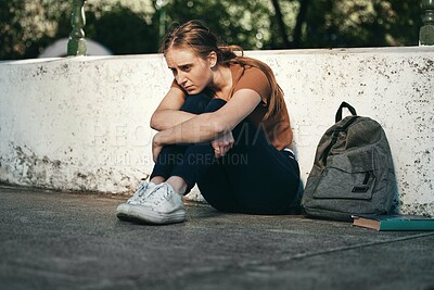 Buy stock photo University, sad and woman student sitting outside in depression for fail on education exam. College, depressed and upset female sit on floor outdoors upset about educational learning book