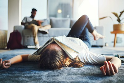 Buy stock photo Burnout, student and tired woman with book on her face for knowledge exhaustion and fatigue. College, university and problem with a female lying on the floor covered in a notebook for studying 