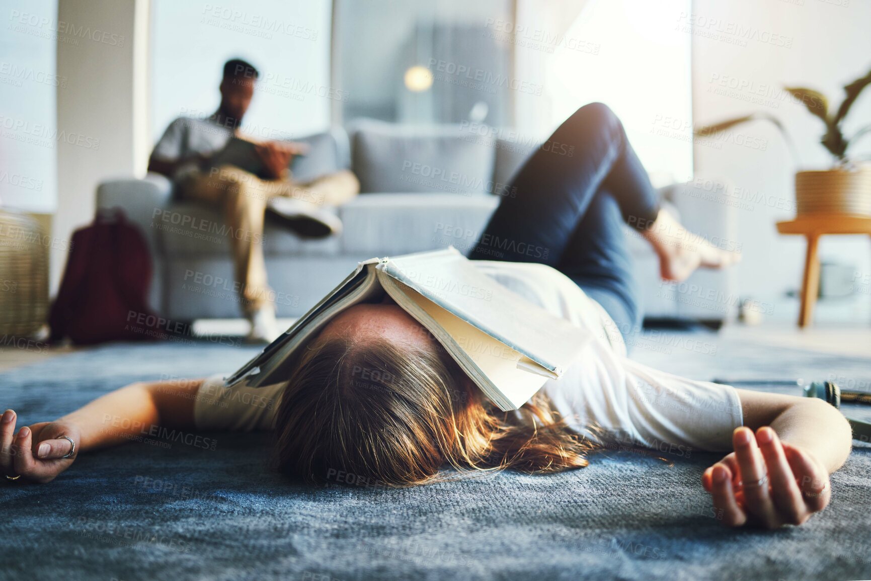 Buy stock photo Burnout, student and tired woman with book on her face for knowledge exhaustion and fatigue. College, university and problem with a female lying on the floor covered in a notebook for studying 