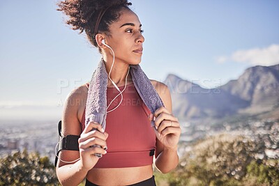 Buy stock photo Sports, music and woman running in nature, stop for rest with view of mountain and city, relax and calm. Radio, fitness and black woman with a towel, on a break from run, exercise and cardio workout