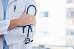 Healthcare, stethoscope and doctor in a hospital with mockup space in consultation room. Medical, service and closeup of professional surgeon after surgery in medicare clinic or center with copyspace