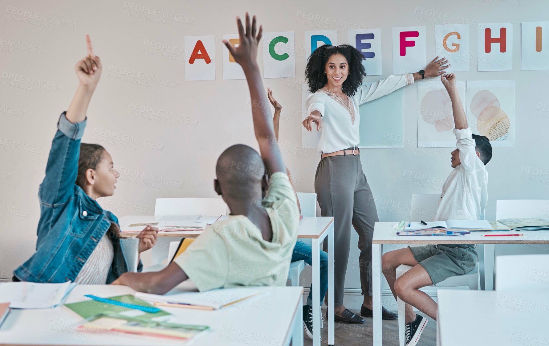 Buy stock photo Question, learning and education at school with kids hands raised to answer alphabet assessment. Classroom, learners and tutor teaching a summary information in a class with smart and clever group