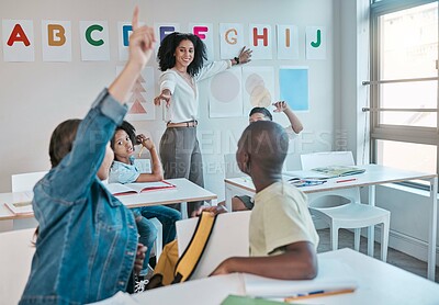 Buy stock photo Teacher, question and woman happy for education and teaching at school with kids learning the alphabet and answer quiz. Raised hands, learners and tutor helping a clever and smart classroom