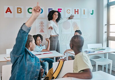 Buy stock photo Teacher, classroom and education at school with children learning the alphabet and answer a question. Raised hands, learners and tutor teaching for child development in a class with smart kids