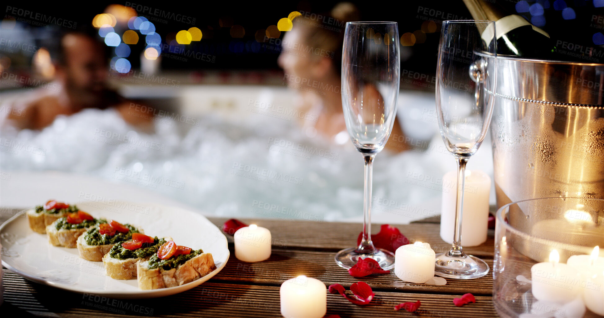 Buy stock photo Glasses, hospitality or night with couple in pool for honeymoon vacation, romance or date at luxury resort. Champagne, food and plate with candle light or man and woman in hot tub at accommodation