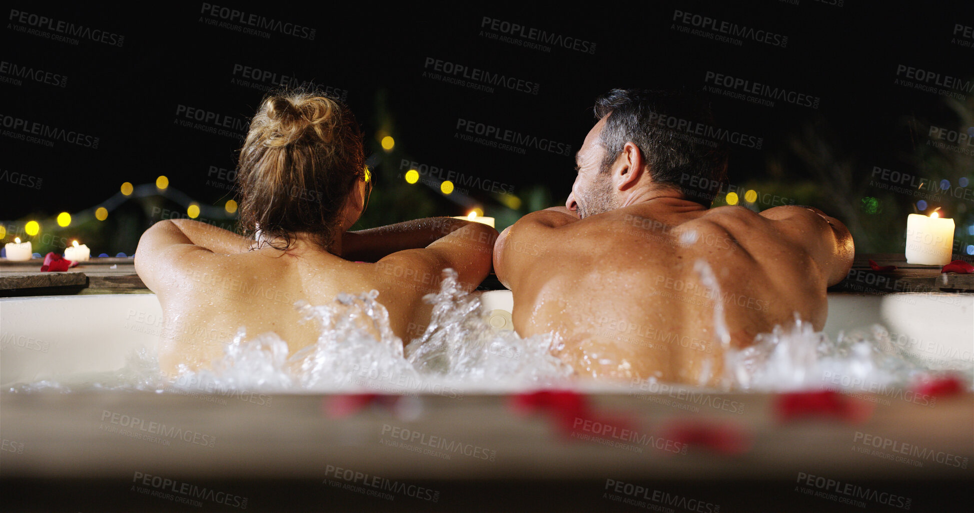 Buy stock photo Couple, night and back with relax in pool for holiday, vacation or honeymoon together at luxury resort. Man, woman or lovers enjoying water with hot tub in late evening for romance or getaway