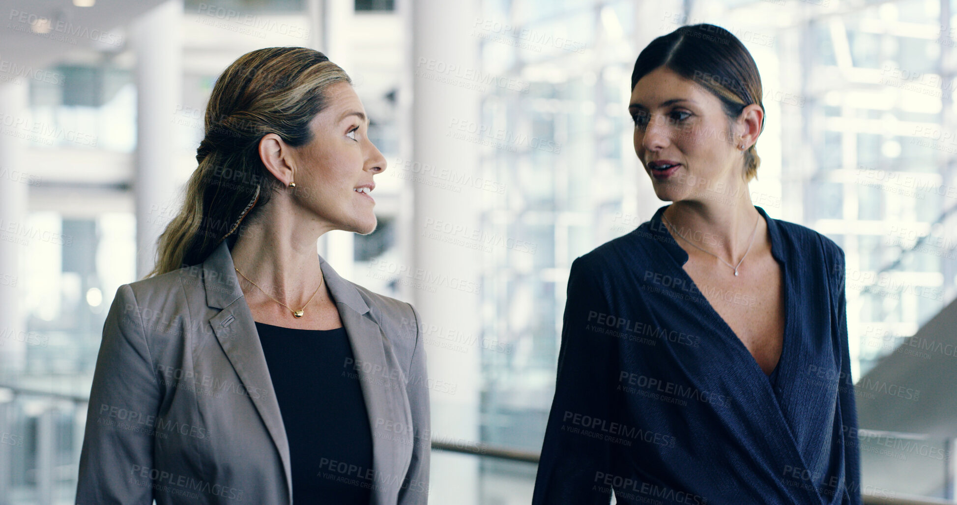 Buy stock photo Business women, lawyers and walking in office building with taking, conversation and discussion. Female people, colleagues and feedback as attorney for law firm, together or collaboration in teamwork