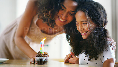 Buy stock photo Mother, girl and happy with candle on cupcake for birthday celebration, support and care at home. People, parent and smile with kid as family for memories, dessert and special occasion with bonding