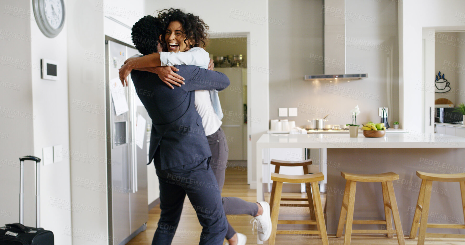 Buy stock photo Couple, hug and excited for reunion in home, support and happiness for security in relationship. People, commitment and care for romantic partnership in kitchen, embrace and love husband to return