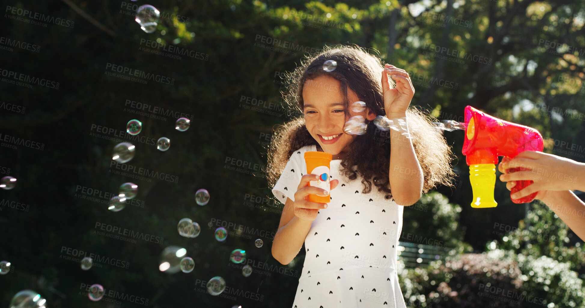 Buy stock photo Excited, child and blowing bubbles outdoor for playful fun, learning activity and sensory stimulation. Smile, kids and wand with soap for games, fine motor skills and creative imagination in backyard
