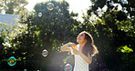 Happy, child and blowing bubbles outdoor for playful fun, learning activity and sensory stimulation. Excited, girl and wand with soap for games, fine motor skills and creative imagination in backyard