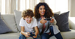 Video, game and mom on sofa with son, smile and competition for bonding together in home. Fun, mother and child on couch with control for playing online with happy energy, electronics and technology