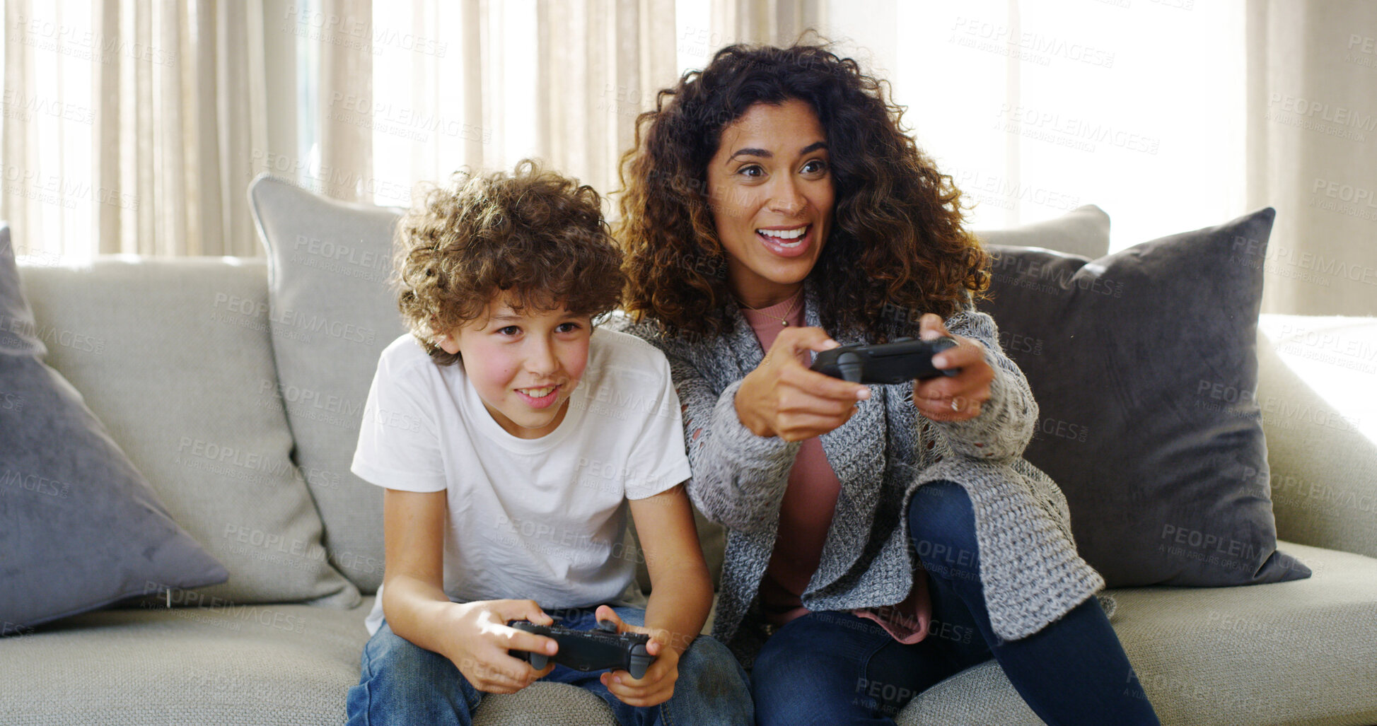 Buy stock photo Video, game and mom on sofa with son, smile and competition for bonding together in home. Fun, mother and child on couch with control for playing online with happy energy, electronics and technology