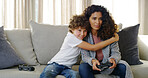 Video game, hug and mom on sofa with son, smile and competition support for bonding together in home. Fun, mother and happy child embrace on couch with control, playing online and steaming technology