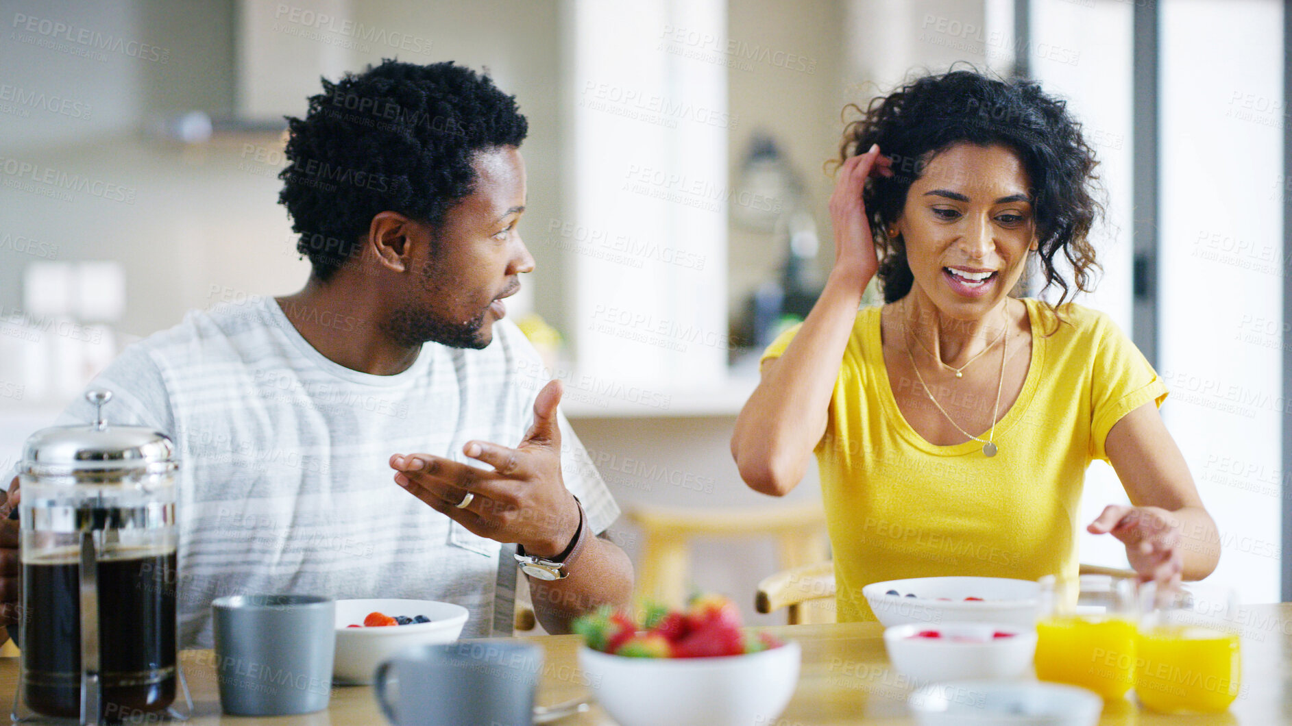 Buy stock photo Interracial couple, kitchen and eating meal for breakfast, bonding together and love with support. Woman, man and sharing in home for nutrition, talk and care for relationship as partner in apartment