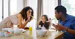 House, parents and girl with celebration, birthday and bonding together with happiness. Family, apartment and father with mother, cheerful and love with daughter, excited and party with breakfast