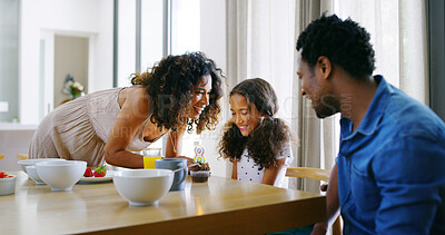 Buy stock photo Parents, girl and happy with candle on cupcake for birthday celebration and support at home. People, interracial family and dessert with kid on memories, special occasion in bonding, love and smile