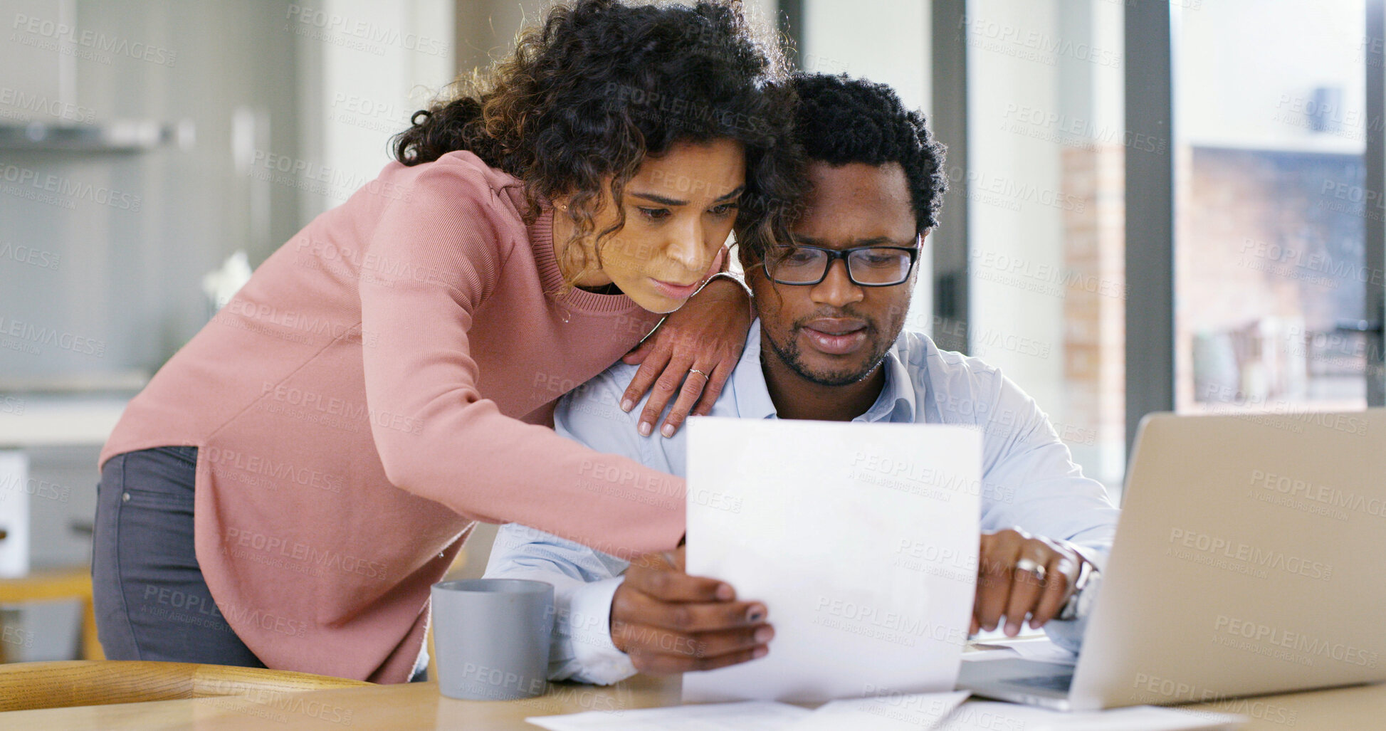 Buy stock photo Interracial couple, documents and laptop with finance for budget planning, expenses or bills at home. Man, woman or paperwork with computer for mortgage payment, invoices or financial report at house