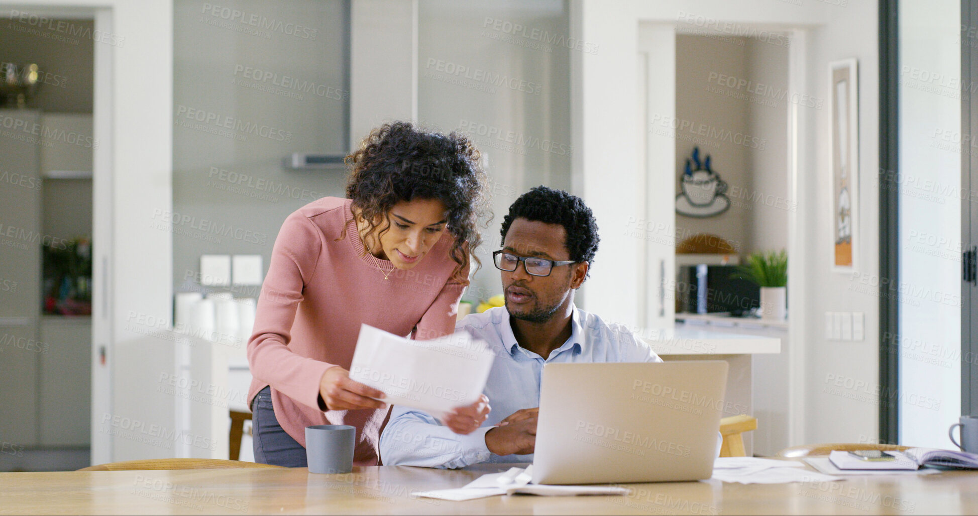 Buy stock photo Interracial couple, documents and discussion with laptop for budget planning, bills or home expenses. Man, woman or paperwork with computer for mortgage payment, invoices or financial report at house