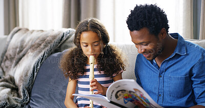 Buy stock photo Learning, music and child with father for flute lesson on sofa with book for notes in home. Education, bonding and dad teaching girl kid to play recorder instrument for talent development in house.