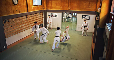 Buy stock photo Martial arts, fight demonstration and people with learning, exercise and karate in dojo. Japan, training and fitness studio with sport, discipline and warrior in taekwondo class in gym above