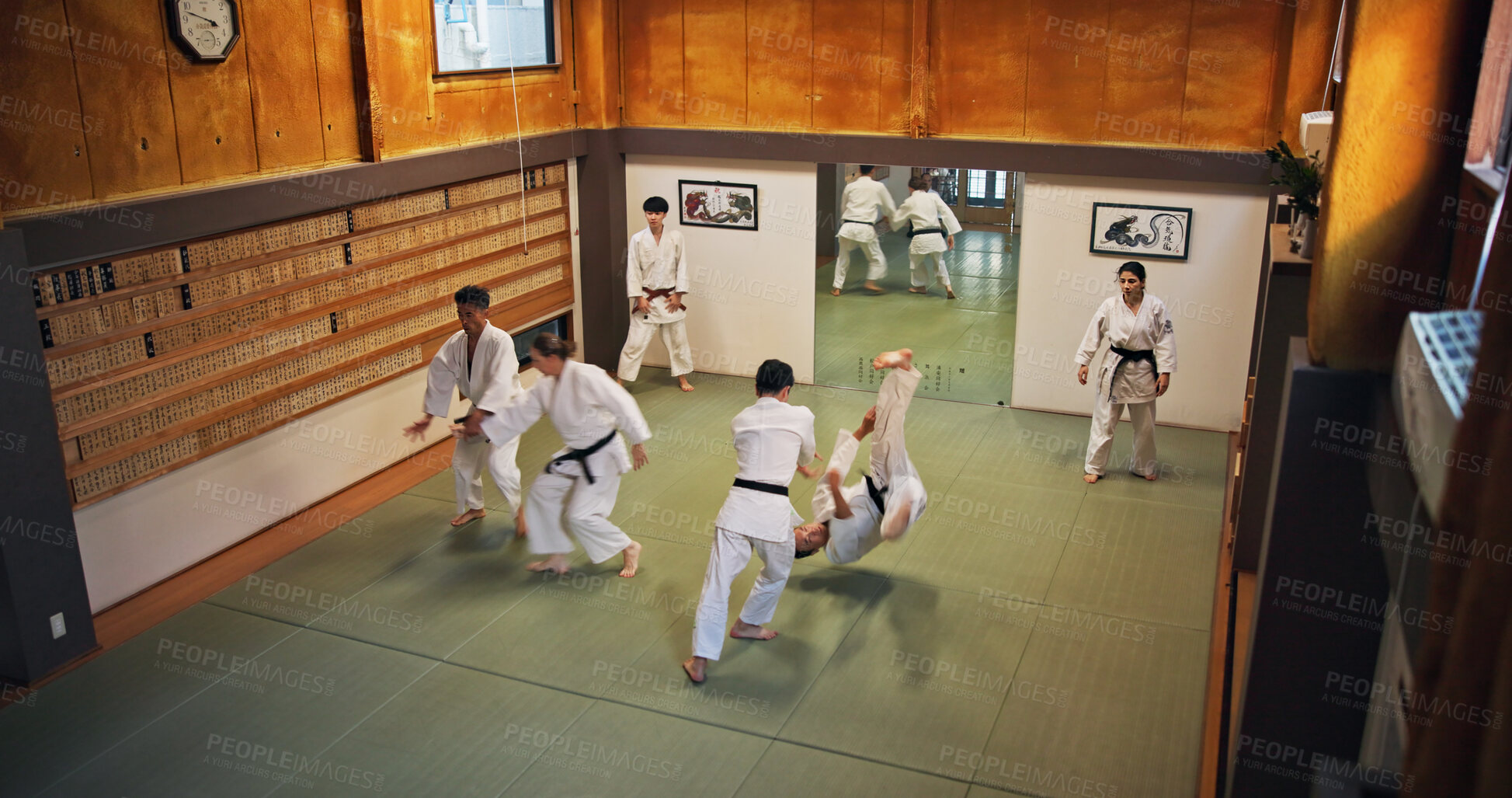 Buy stock photo Martial arts, fight demonstration and people with learning, exercise and karate in dojo. Japan, training and fitness studio with sport, discipline and warrior in taekwondo class in gym above