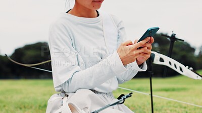 Buy stock photo Archery, person or hands of archer with phone for training, social media or outdoor game. Arrow, shooting range or athlete with mobile for texting on break in match with skills or sports app in Japan