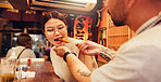 Japanese man, woman and eating with Asian food in city for romantic dinner, meal or anniversary. Couple, feeding and bonding together with holiday, vacation or care for tourism or night in restaurant