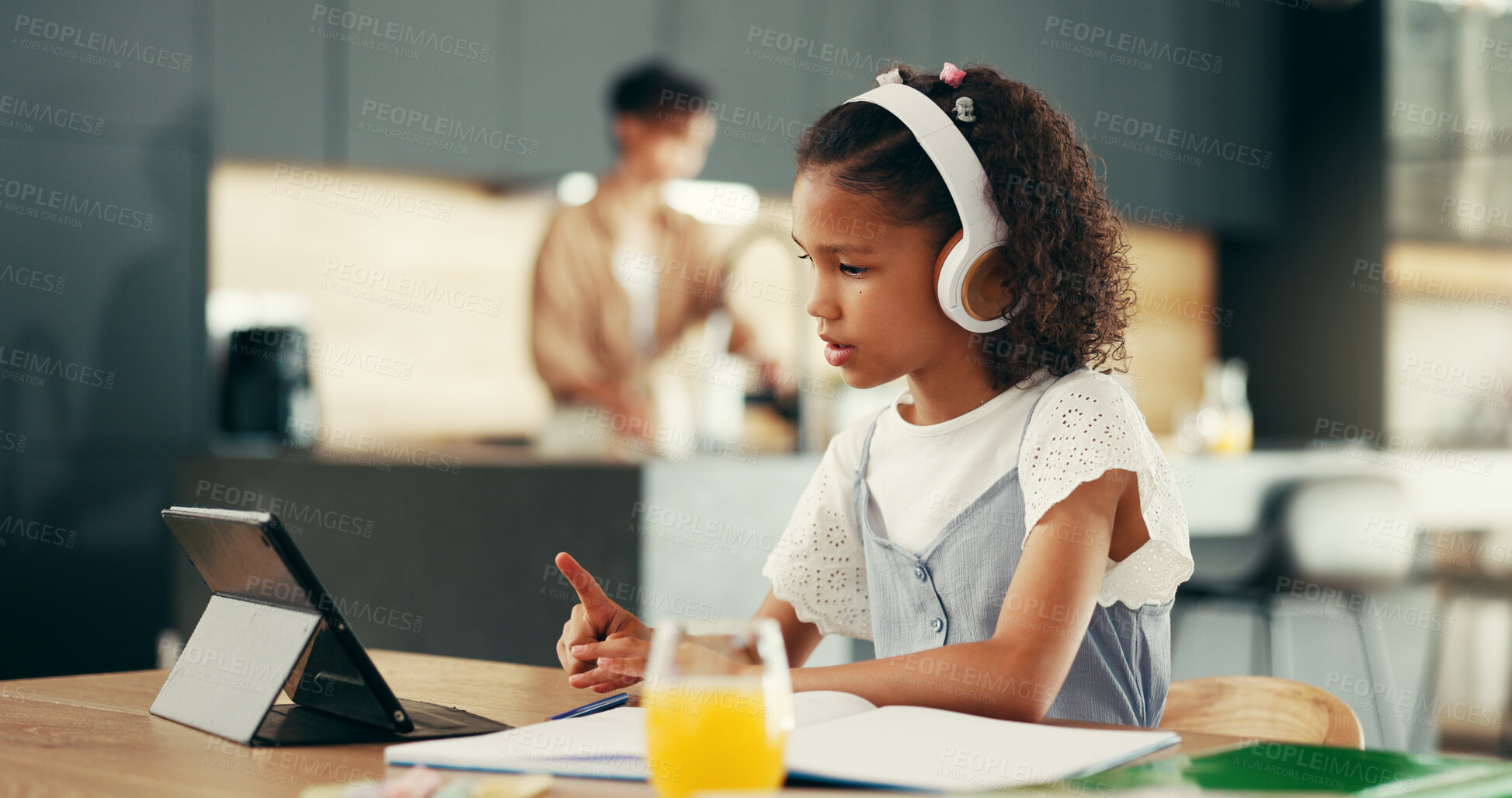 Buy stock photo Girl, tablet and education with studying in kitchen for elearning, video or headphones for online course. Child, notebook and touchscreen with point, scholarship and school project in family house