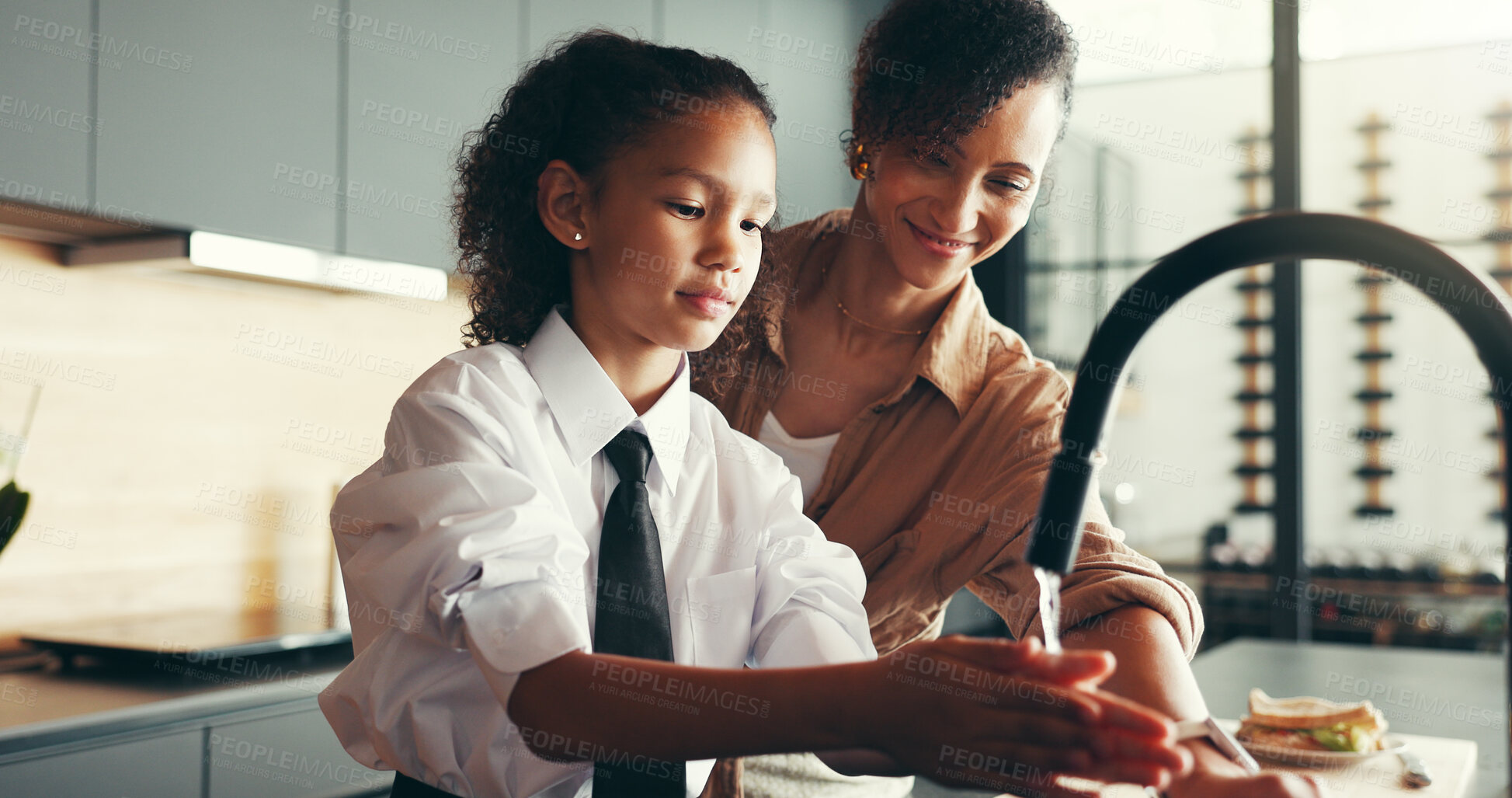 Buy stock photo Mom, girl and school uniform with washing hands in morning for breakfast and elementary education at home. Apartment, people and parent with kid in kitchen with smile for hygiene and remove germs