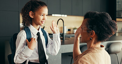 Buy stock photo Mom, girl and school uniform with high five in home for preparing or ready for elementary education. Apartment, people and parent with kid for first day with smile, pride and child development