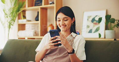 Buy stock photo Phone, relax and smile with woman on sofa in living room of home for app or social media browsing. Communication, text message and typing with happy person scrolling dating site for match or swipe