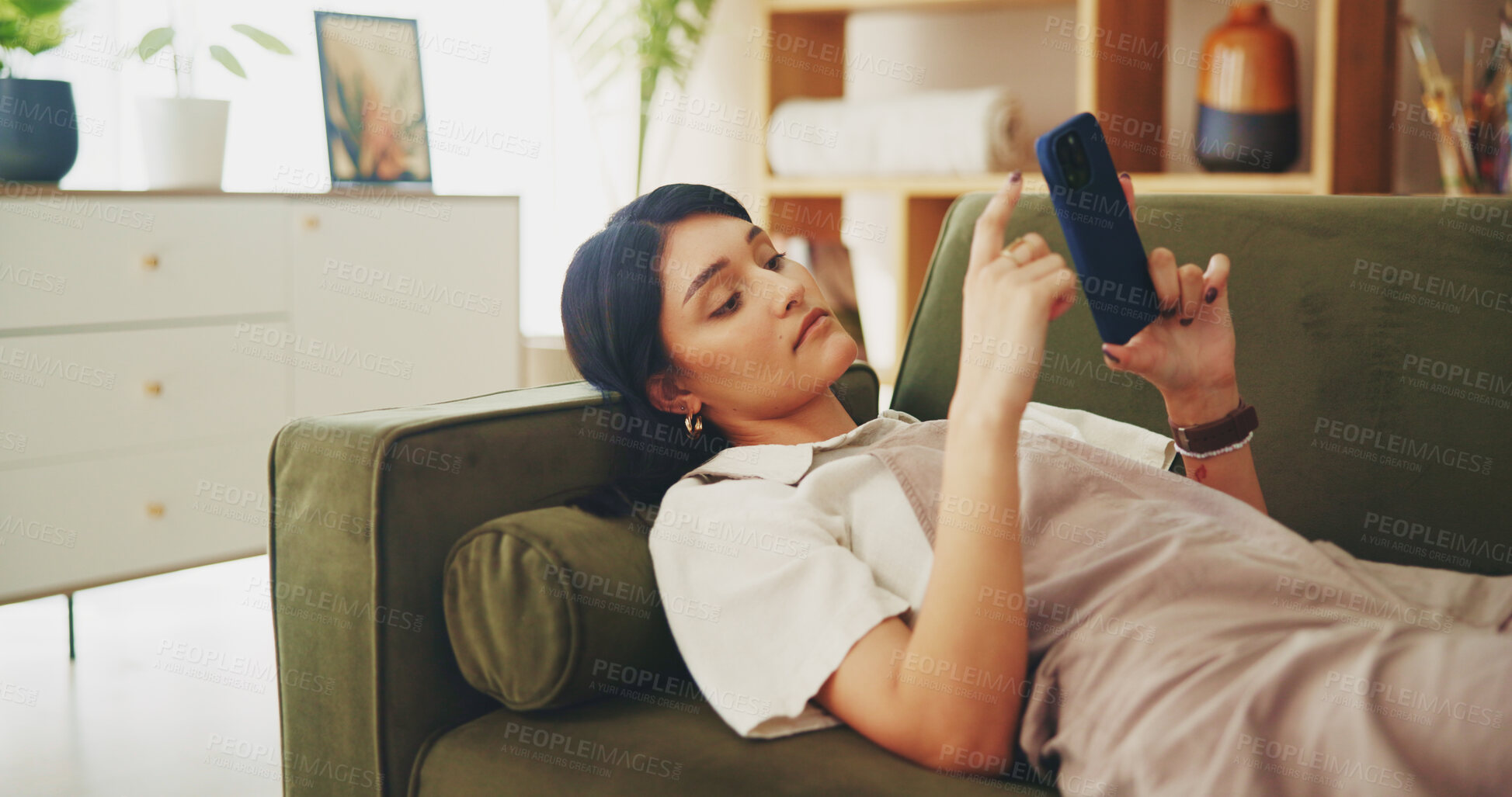 Buy stock photo Relax, phone and scroll with woman on sofa for streaming, social media and networking app. Connection, online news and internet with person in living room at home for mobile, web and communication 