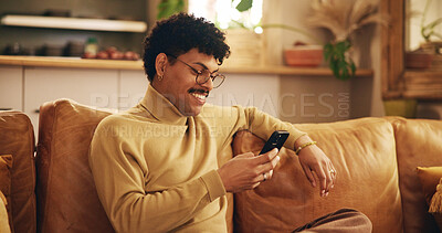 Buy stock photo Man, phone and texting on sofa, happy and reading in living room, chat and mobile app in home. Person, smartphone and check notification with contact on lounge couch with social network at apartment