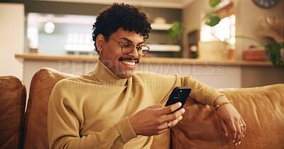 Buy stock photo Portrait, man and mobile phone with smile, texting or communication on couch in home for relax. Male person, positive and happy on technology in apartment for post, online and website in lounge