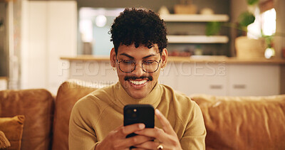 Buy stock photo Smartphone, young man and mobile app with smile, texting or communication on couch in home for relax. Male person, positive and happy on technology in apartment for post, online and website in lounge