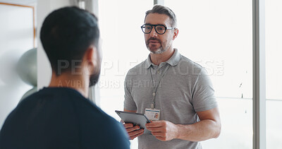 Buy stock photo Physiotherapy, tablet and talking with man and athlete in clinic for rehabilitation, healthcare or consulting. Support, medical and chiropractor with people for healing, advice or physical therapy 