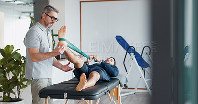 Buy stock photo Chiropractor, people and band for stretching legs at clinic, helping and recovery on table. Men, flexibility exercise and physiotherapy for rehabilitation treatment, support and healing service