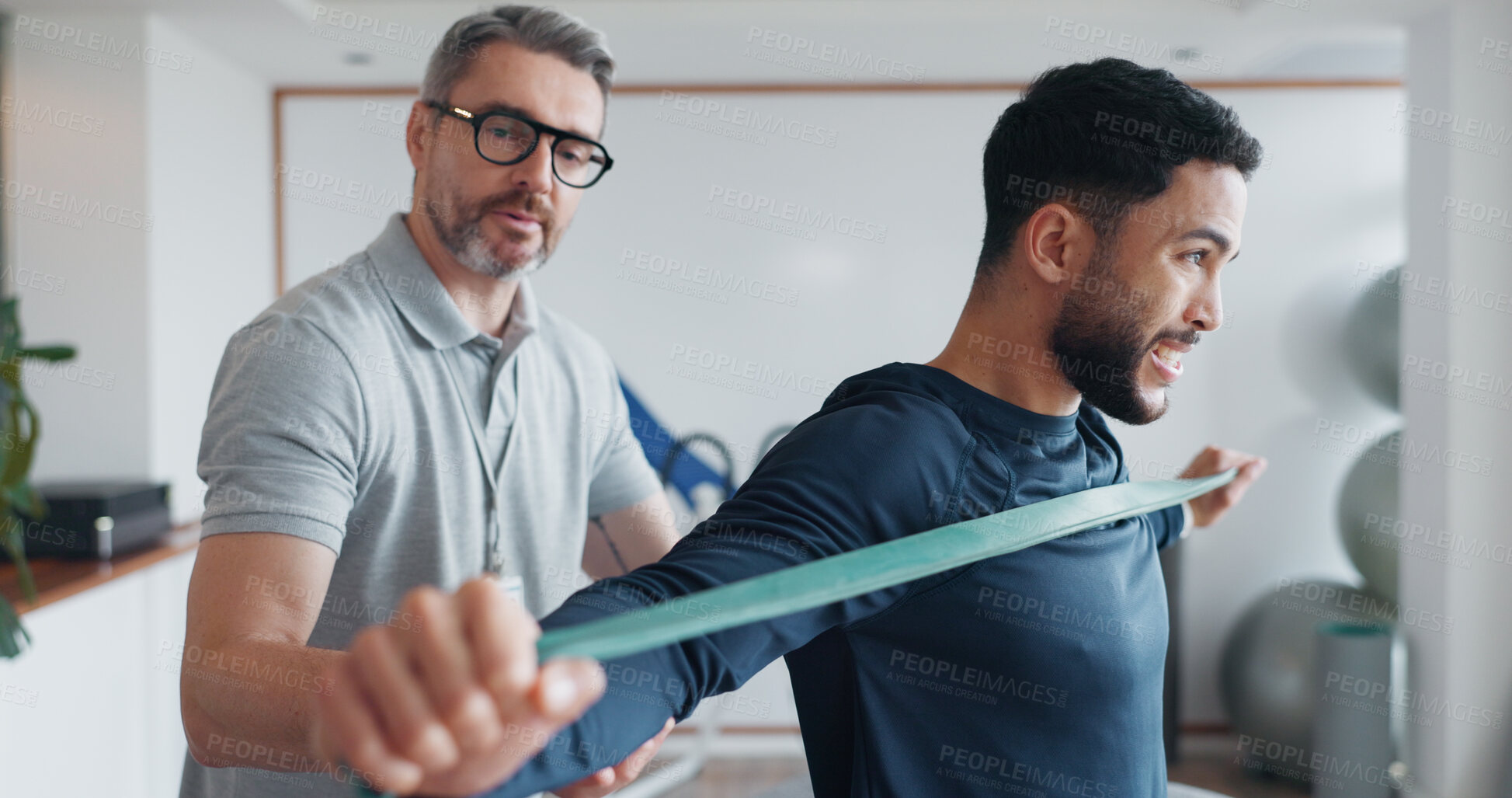 Buy stock photo Physiotherapy, resistance band and healthcare with man and athlete in clinic for rehabilitation, consulting or stretching. Support, medical and muscle with people for healing, advice or recovery