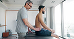 Men, back pain and injury with massage with physiotherapy at clinic with recovery, process and relief. People, patient and biokinetics for ache, spine and rehabilitation for wellness at hospital
