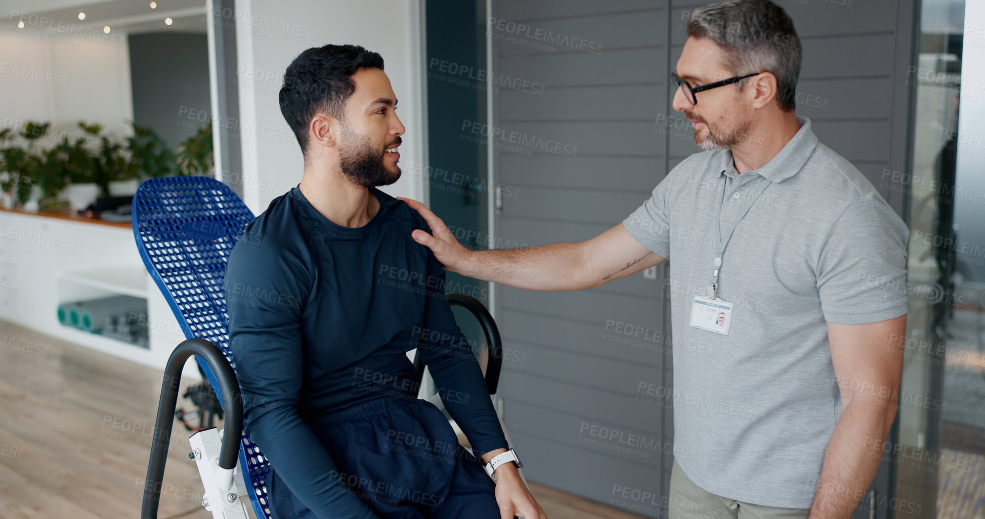 Buy stock photo Man, physiotherapist and consulting for recovery at clinic with fitness chair, support and guide for wellness. People, discussion and gear for exercise, advice and happy for rehabilitation process