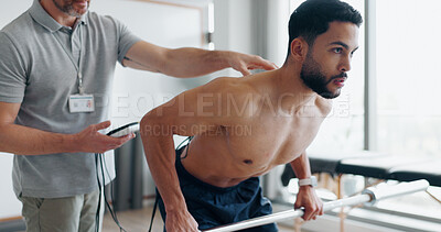Buy stock photo Physiotherapy, training and monitor with man in clinic for biofeedback, muscle stimulation and track progress. Rehabilitation, healthcare and fitness with people for chiropractor, help and healing