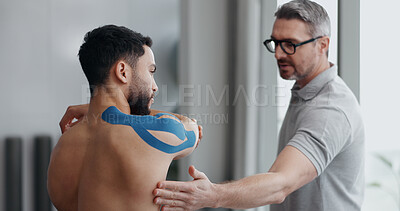Buy stock photo Physiotherapist, man and stretching with tape for recovery, injury and guide for health at clinic. People, help and support with exercise for shoulder pain with muscle in rehabilitation at hospital