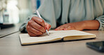 Business woman, hands and writing with book for schedule planning, agenda or tasks in diary at office desk. Closeup, female person or journalist taking notes with pen for project reminder or report